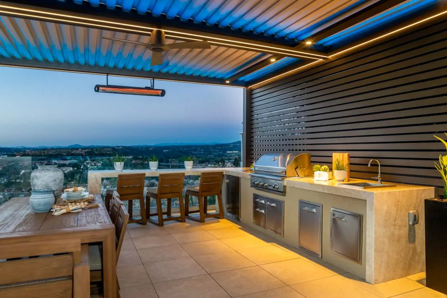 A stylish patio setup with a built-in barbecue station, sleek countertops, and vibrant blue lighting, perfect for outdoor cooking.